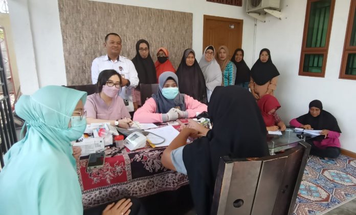 Foto kepala UPT Puskesmas Tanjungbatu Azman paling kanan, tim medis Pospindu saat pengecekan kesehatan berkala di Gang Nuri kelurahan Tanjungbatu kota kecamatan Kundur Rabu 22/2